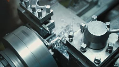 Metal Lathe Cuts Spinning Metal Rod