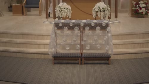 Decorated wooden bench for bride and groom at their Catholic church wedding