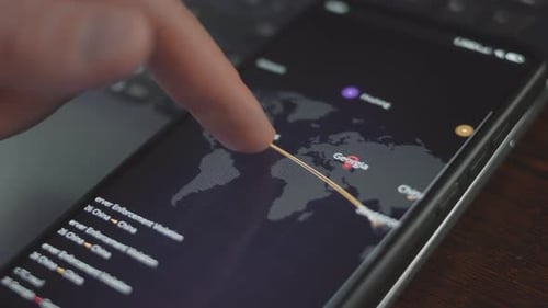Finger Interacts with World Map on Phone Screen
