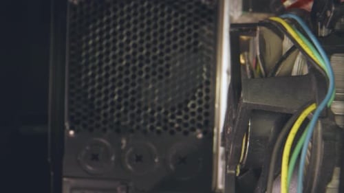 Dolly from inside of a computer case, past the motherboard and components.