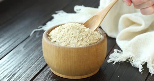 Nutritional Yeast Flakes in Wooden Bowl with Spoon