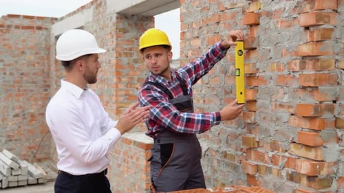 Two Engineers Working in a Construction Site Close Up