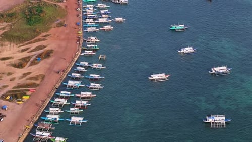 Aerial drone view of Coron Port, capturing the boats and vibrant coastal scenery.