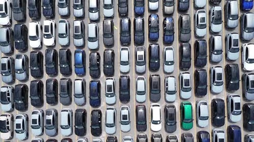 Aerial Overhead View of Rows of New Cars Arranged in a Large Parking Lot in the USA
