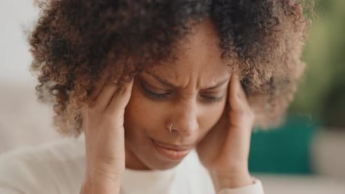 Adult Woman Suffering Migraine Closeup View of Female Face with Expression of Pain Hard Headache