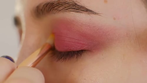 Makeup Artist Applying Eye Shadow Makeup to Model's Eye Close Up View Smoky Eyes Left View Slow