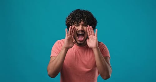 Closeup Serious Angry Indian Guy Shouting Standing Over on Blue Studio Background