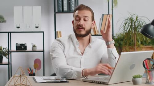 Businessman Working on Laptop Meditating Doing Yoga Breathing Exercise in Lotus Position at Office