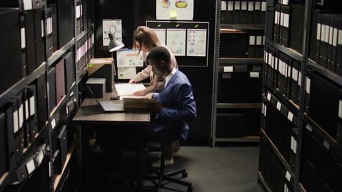Man and Woman Working Together in Small Office