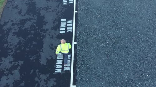 Labour worker walking to work with dignity aerial