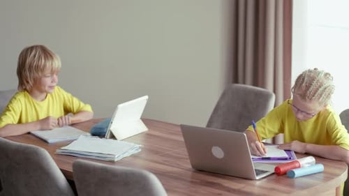 Children Studying and Writing at Home Table