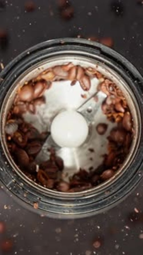 Rotating Coffee Beans in Coffee Grinder Grinding Roasted Coffee Beans