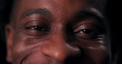 A Closeup Shot of an African American Man's Eyes Reveals a Hidden Depth of Emotion As His Genuine