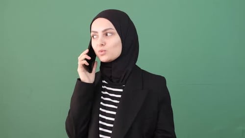 Woman in Hijab Speaking on Smartphone