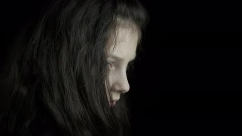 Child Crying with Tears on Dark Background