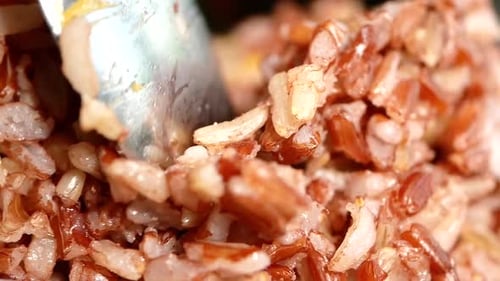 Close-up of Cooked Brown Rice Stirred with Spoon