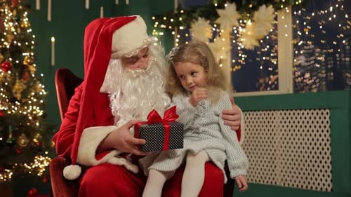 Santa Claus Gives a Gift to a Young Girl