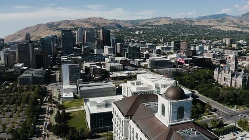 Aerial View of City with Mountains and American Flag