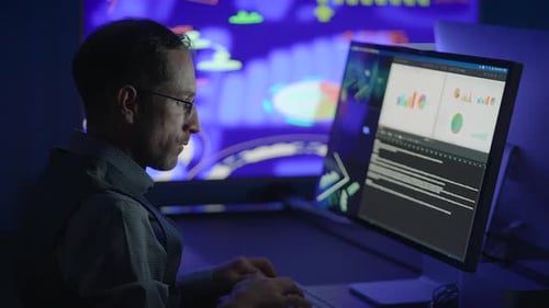 A Dedicated Data Analyst Works Late Using Advanced Technology and Visualizations