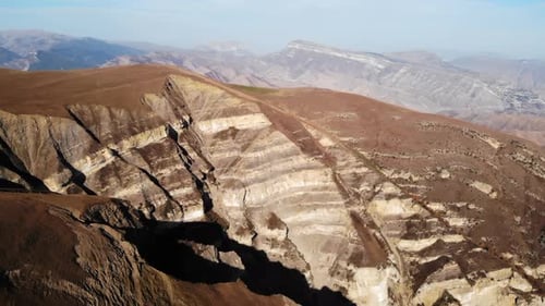 Stunning Aerial View of Brown and White Layered Mountains