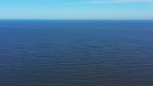 Aerial view with a drone the Mediterranean Sea with only the blue water all over the horizon 4K