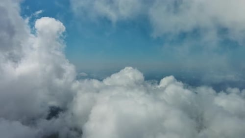 Flying Through White Clouds Over Sea
