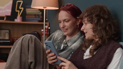 Friends Using Smartphone Together at Home