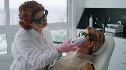 Woman Lying Rejuvenation Laser Procedure at Modern Cosmetology Clinic Close Up