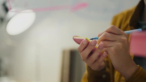 Business, Company Employees Writes A Note In A Modern Office Space. A Professional Conducts