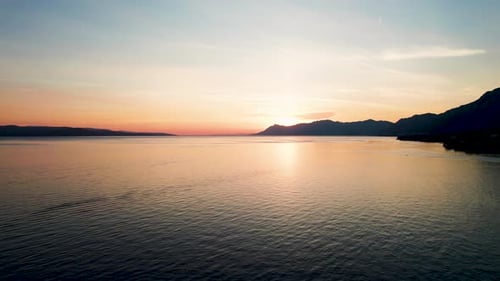 Aerial view of tranquil sunset over sea and mountains, Croatia.