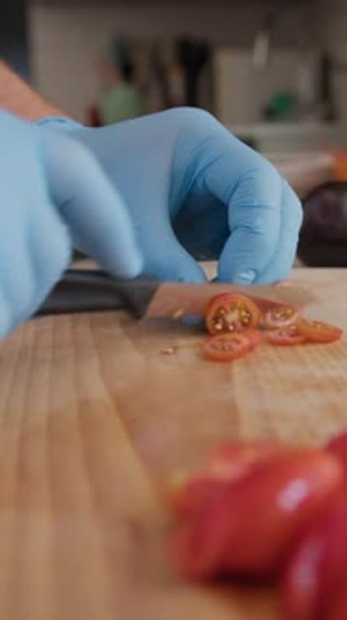 Chef Cuts Red Cherry Tomatoes On A Wooden Cutting Board