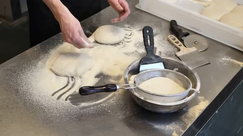 Preparing Pizza Dough With Flour on Metal Table