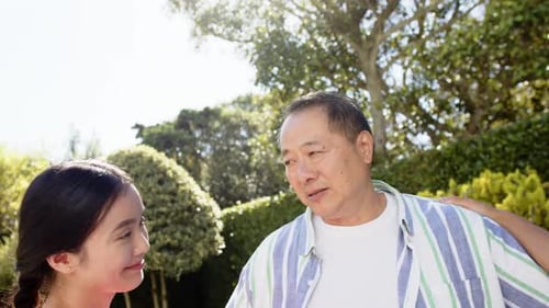 Happy Family Hugging in Suburban Yard on Sunny Day
