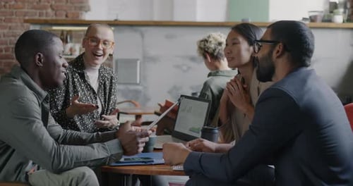 Diverse Team Collaborates on Business Plan in Workspace