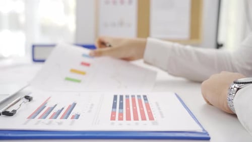 Man Analyzing Charts in Modern Office Workplace