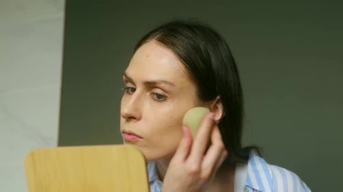 Woman Applying Makeup With Sponge