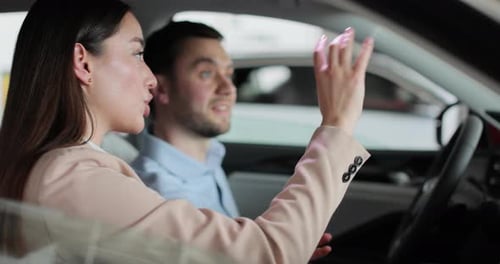 Young Man and Car Seller Talking in the Car Concept of Car Shopping Buying and Dealership