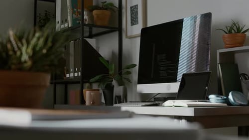 Computer Monitor, Wireless Keyboard, Tablet and Open Notebook on Work Desk