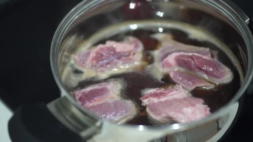 Raw Meat Simmering in Pot