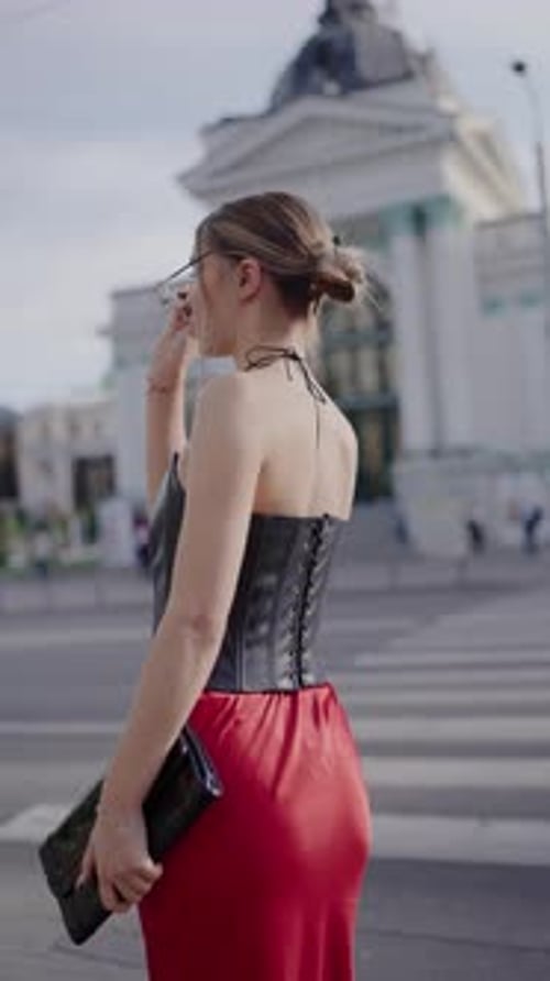 Fashionable Woman in Red Dress and Sunglasses on Urban Street