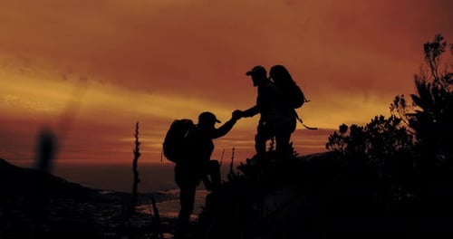 Hikers Silhouette Climbing Mountain at Sunrise
