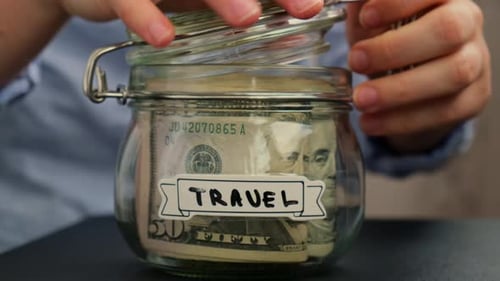 Female Hands Take Money From Glass Jar Full of American Currency Dollars Cash Banknote with Text