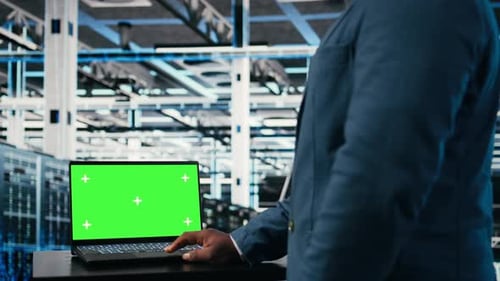 Green Screen Mockup Laptop Network Management and Engineer in Server Farm