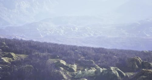 Scenic Landscape View of Rocky Hills and Rolling Terrain in Soft Light