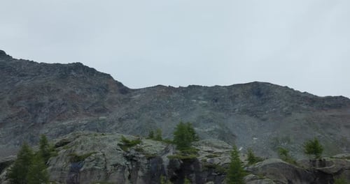 Scenic pan shot of rugged, rocky mountains of Alpe Prabello, Valmalenco, Italy.
