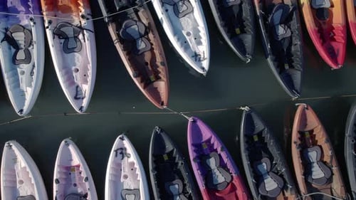 Aerial top view of a group of canoes in lake.