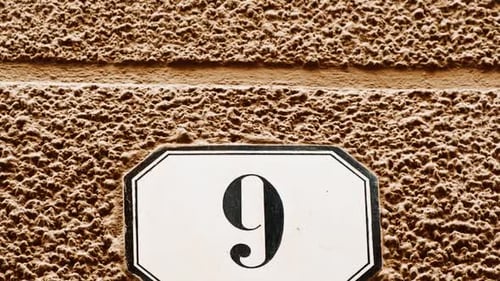 Number 9 (nine) Affixed to a Building