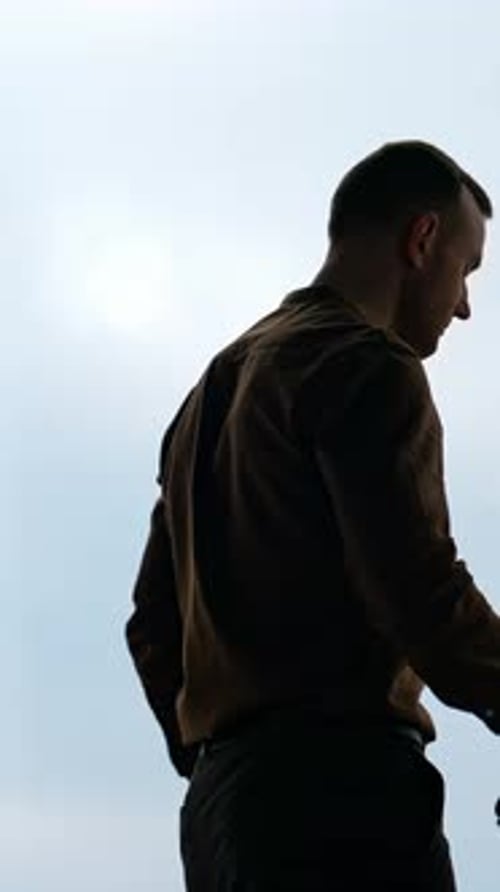 Man Silhouette Looking at Watch in Office