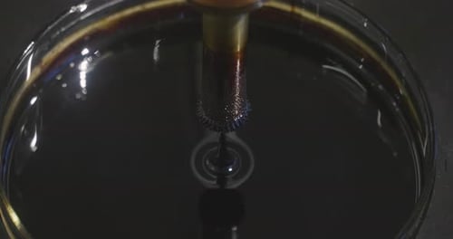 In a metallurgical industry, a magnet is dipped in a liquid metal.