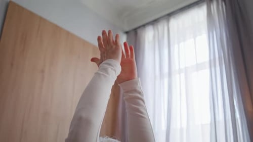 Senior Woman Stretching Arms in Peaceful Home Setting